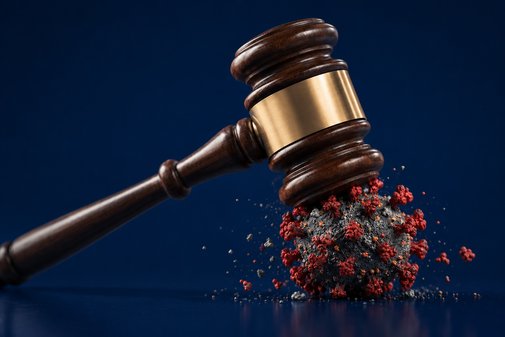 Gavel striking a coronavirus particle – civil litigation during the pandemic